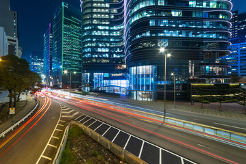Fototapeta na wymiar Night scenery of modern office building and traffic in downtown district of Hong Kong city