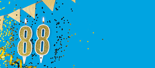 Golden candle number eighty eight. Birthday or anniversary card with the inscription 88 on blue background. Anniversary celebration. Banner.