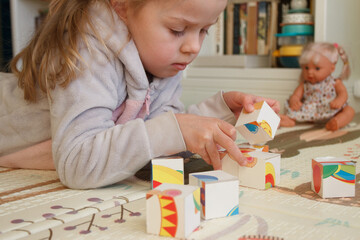 Little cute girl spending time in the playroom, soft focus background