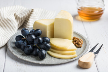 Italian cheese Caciotta on a ceramic plate, selective focus