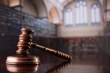 Law concept. Gavel, scale, legal code and Themis sculpture in the law faculty library.