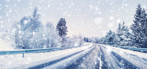 Snowfall on the curvy highway in winter natural park.