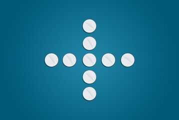 White pills on a blue background in the shape of a medical cross. Concept of health care, medical preparations and recovery