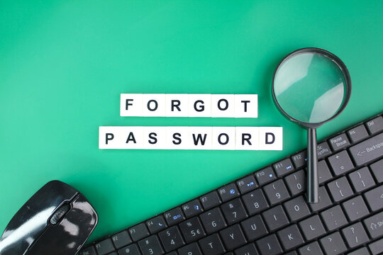 mouse, laptop keyboard and magnifying glass with alphabet letters of the word forgot password. the concept of forgotten password. the concept of inaccessibility