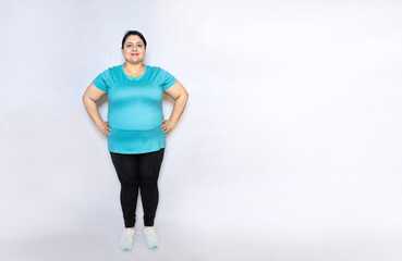 Front view of happy beautiful overweight fat indian woman standing isolated over white background,...