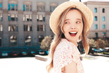 Young beautiful smiling hipster woman in trendy summer clothes. Sexy carefree woman posing on the street background at sunset. Positive model outdoors. In hat. Screams, shouts