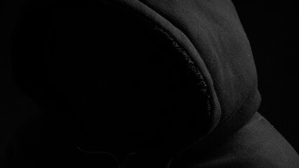 Silhouette in casual sportswear with hood. Faceless unrecognizable man without identity