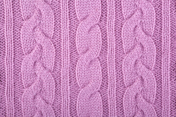 fabric is knitted from woolen yarn. Knitted background. Needlework, handicrafts, hobbies. Close-up