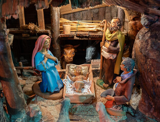 Sutrio, Italy - December 29, 2022: Christmas nativity scene with the holy family, shepherd and...