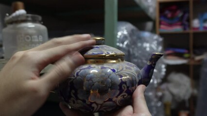 dusting off old antique teapot