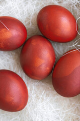 Obraz na płótnie Canvas Fresh red eggs and some straw in a wooden crate on a white background. Chicken eggs. Easter concept .Top view