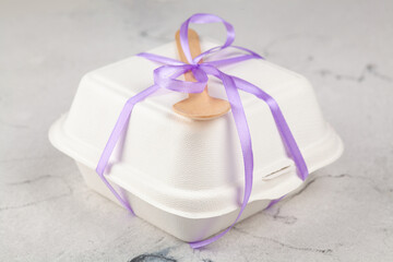 Bento Cake. Portioned trandy dessert for one person in eco box with purple ribbon, small cake