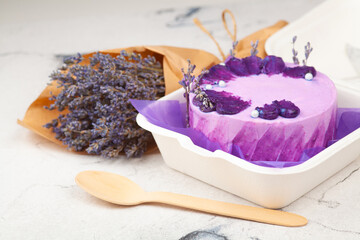 Bento Cake. Small cake in lilac colors in an eco-box. Portion trendy dessert per person
