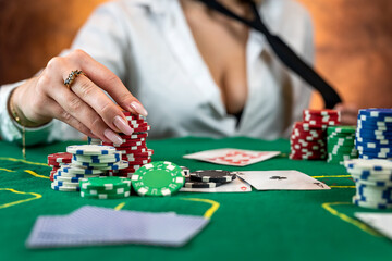 Fototapeta na wymiar girl in poker has won everything and takes all the chips with her own hands.