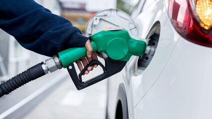 Man Refill and filling Oil Gas Fuel at station. Gas station - refueling. To fill the machine with...