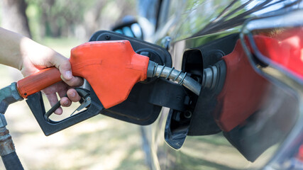 Man Refill and filling Oil Gas Fuel at station. Gas station - refueling. To fill the machine with...