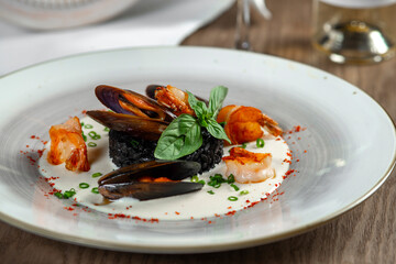 seafood, mussels, salmon on a white plate