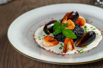 seafood, mussels, salmon on a white plate