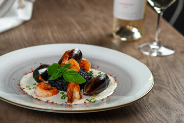 seafood, mussels, salmon on a white plate