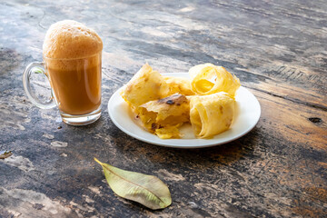 Malaysian food. Roti tissue, roti tisu, or tissue prata is a sweet flatbread. Sweet roti eat with...