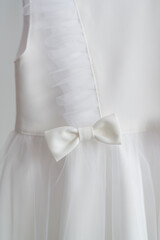 Bow on a white elegant dress close-up