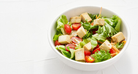 mix salad green leaves tofu on white table background. mix salad green leaves tofu cube on white...