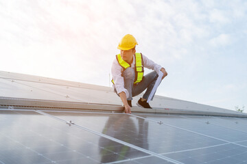 Engineers wearing a uniform walking on roof inspect and check solar cell panel, solar cell is smart ecology energy sunlight alternative power factory concept.