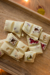 Handmade white chocolate on a wooden tray