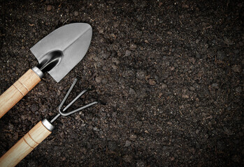 garden tool lies on the soil ready for planting young plants