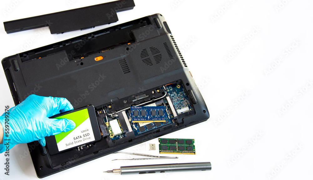 Poster technician installing ssd drive in old computer, upgrading computer
