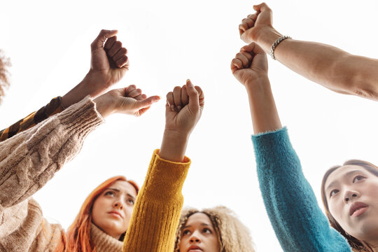 Multiracial women making fist at protest