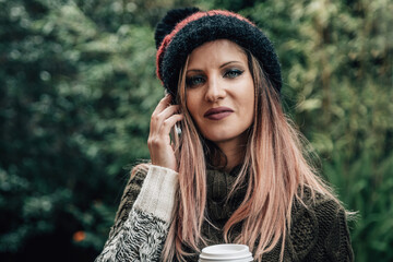 urban woman talking on phone and drinking coffee