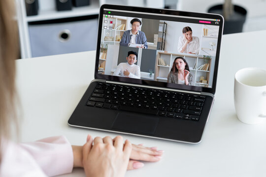 E-learning course. Video chat. Digital education. Female coach working online with diverse students group on laptop screen at workplace.