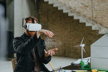 Architect wearing VR simulator gesturing with wind turbine design at construction site