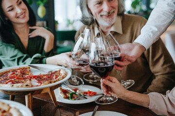 Happy family making toast together sitting at dining table in cafe