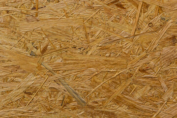 OSB board texture. Brown wooden background. Simple pressed chipboard pattern. Brown wood texture. Chip board background