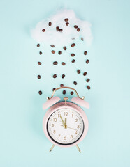 Wake up, time for a coffee break, alarm clock with roasted beans raining from a cloud