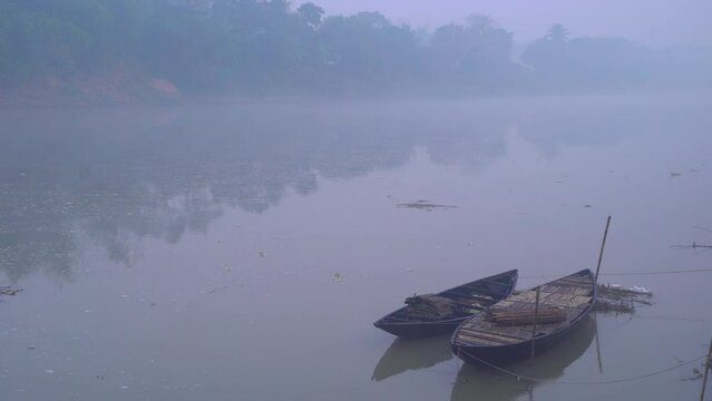 There are boats tied to the river at dawn of winter.
