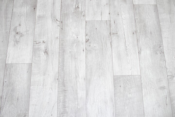 White linoleum with a wood texture. Types of floor coverings.
