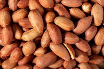 Peanuts on dark background. Pile of peanuts. Studio shoot. Top view