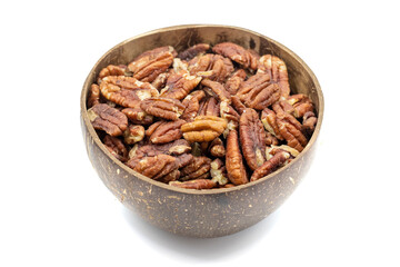 Pecan isolated on white background. Pecans in a coconut bowl. healthy fat. Heap shelled Pecans nut. Close up. Keto diet. Studio shoot. close up