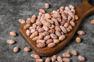 Salted peanuts on dark background. Peanuts on wood serving board. Studio shoot. close up