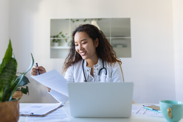 Asian female doctor having online therapy with her patient's, giving them advice while using telemedicine as a new normal during COVID-19 pandemic outbreak