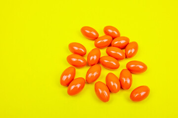 Orange supplements pharmaceutical medicine pills capsules and tablets spilling out of a drug bottle. Alternative medical, holistic anti-aging supplements, healthy health and medical healing therapy