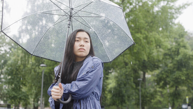 Sad woman feeling cold under rain, waiting for someone, bad weather, depression