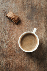 Cup of coffee with cantuccini (Italian biscuit) on rustic stone background. Top view. Copy space.