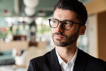 Fototapeta premium Young white businessman in formal wear working at office