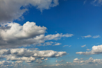 White dense clouds in the blue sky.
