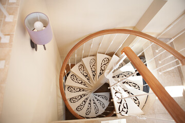 White spiral staircase in interior of flat or house, top view