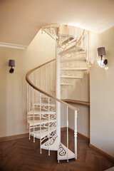 White spiral staircase in interior of flat or house
